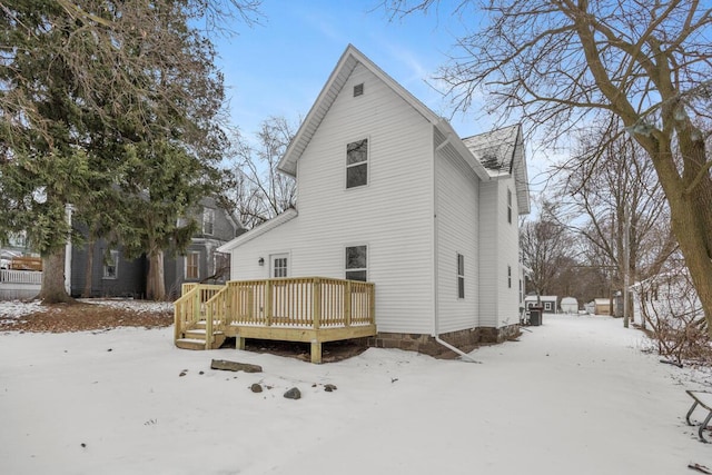 snow covered property with a wooden deck