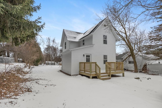 snow covered property featuring a wooden deck