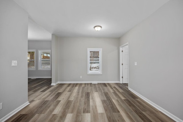 empty room with wood finished floors and baseboards