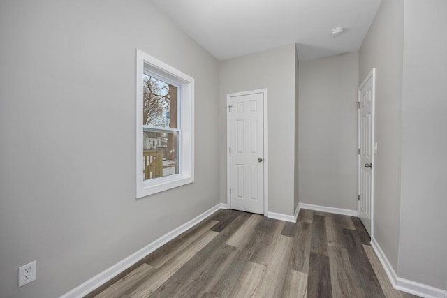 hall with wood finished floors and baseboards