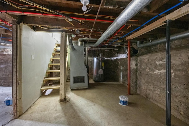 unfinished below grade area with electric water heater and heating unit