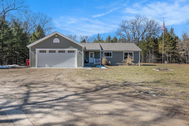 ranch-style home featuring a garage and driveway