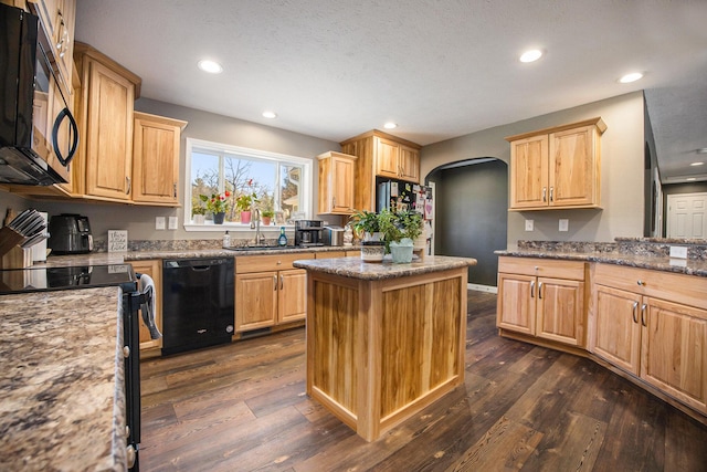 kitchen with dark wood finished floors, black appliances, arched walkways, and light brown cabinetry