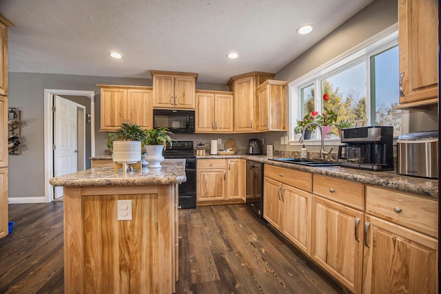 kitchen with a center island, dark wood-style floors, black appliances, and a sink