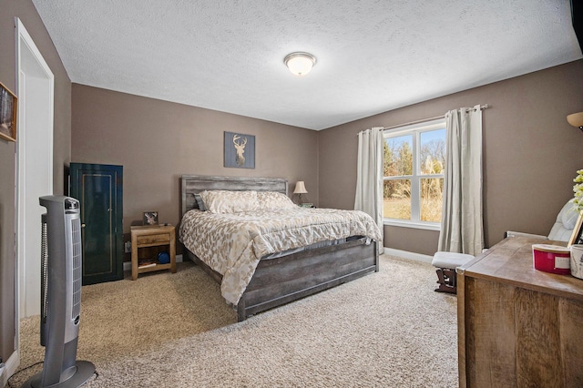 carpeted bedroom with a textured ceiling and baseboards