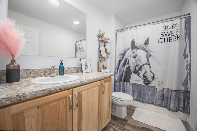 full bath with vanity, a shower with curtain, toilet, and wood finished floors