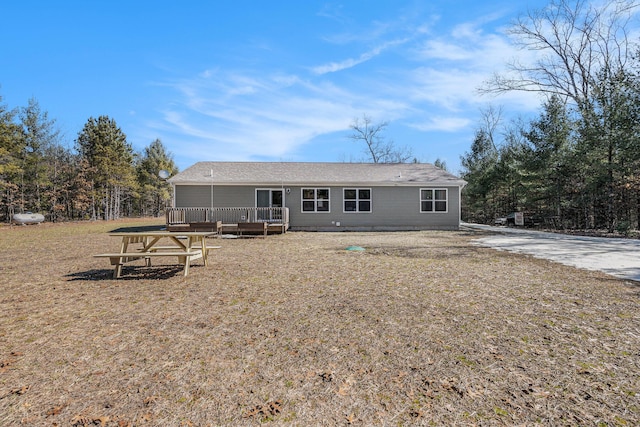 back of house with a wooden deck