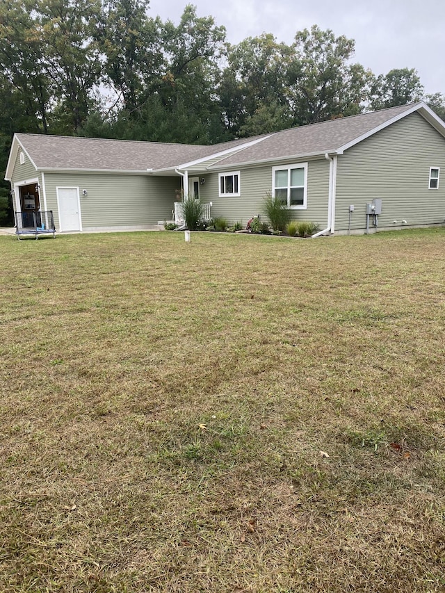 back of house with a lawn