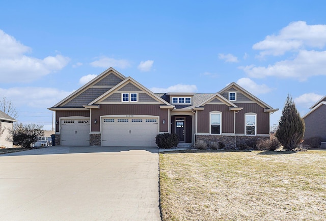 craftsman-style house featuring stone siding, driveway, a front lawn, and board and batten siding