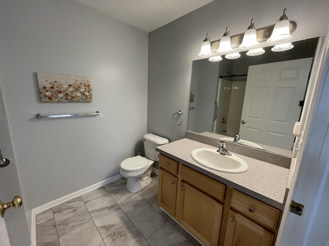 bathroom featuring toilet, marble finish floor, baseboards, walk in shower, and vanity