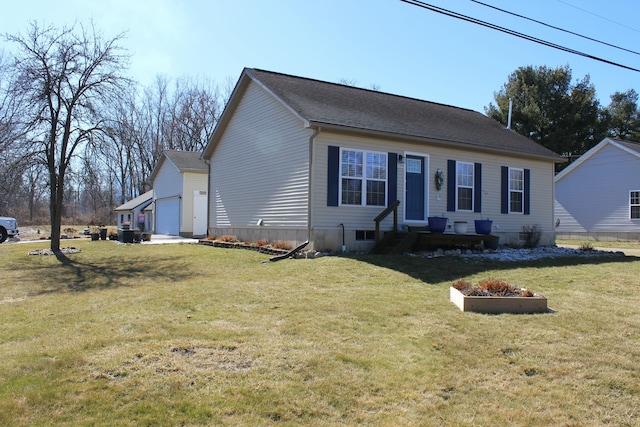 view of front of home with a garage, an outbuilding, and a front yard