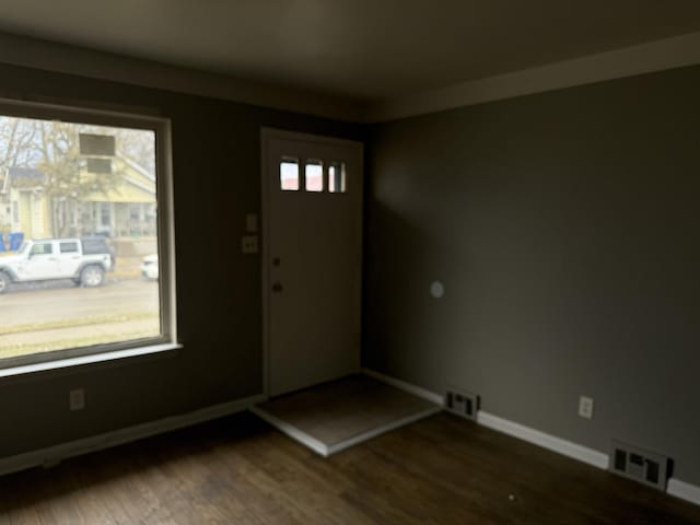 entrance foyer featuring visible vents, dark wood finished floors, and baseboards