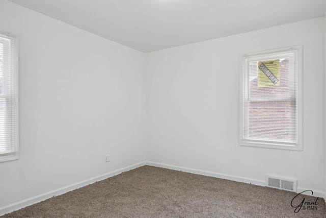 11620 Rossiter St, Detroit, MI 48224 - spare room featuring carpet, visible vents, and baseboards