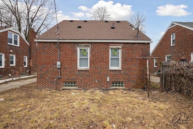 11620 Rossiter St, Detroit, MI 48224 - back of property featuring brick siding, a shingled roof, and fence