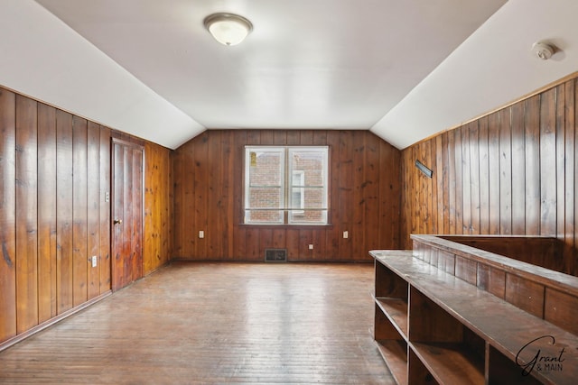 11620 Rossiter St, Detroit, MI 48224 - bonus room featuring lofted ceiling, wood walls, visible vents, and wood finished floors