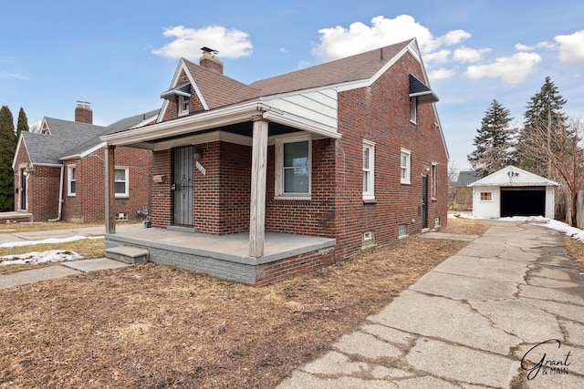 view of front facade with a porch, a garage, brick siding, an outdoor structure, and a chimney