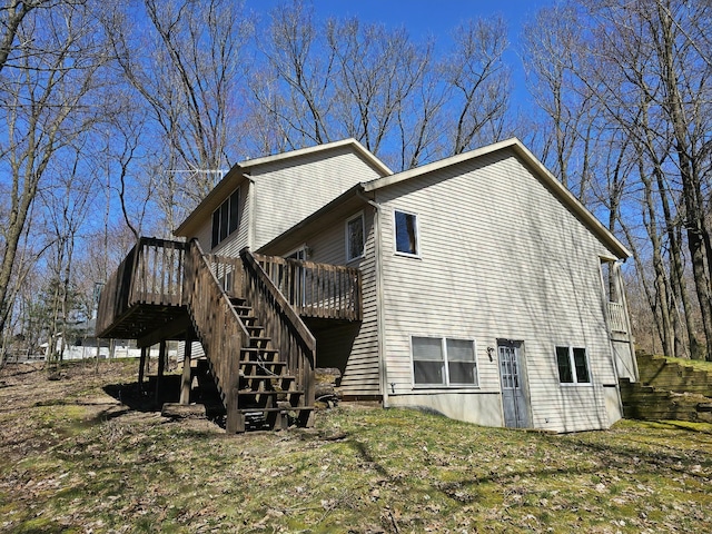 back of property with stairway and a wooden deck