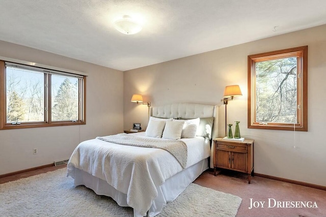 carpeted bedroom with visible vents and baseboards