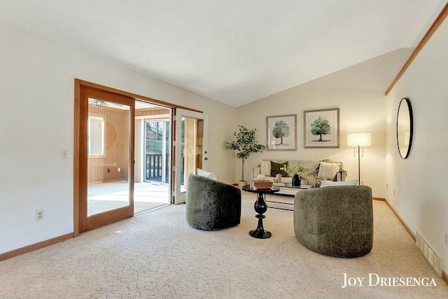 interior space featuring carpet flooring, baseboards, visible vents, and vaulted ceiling