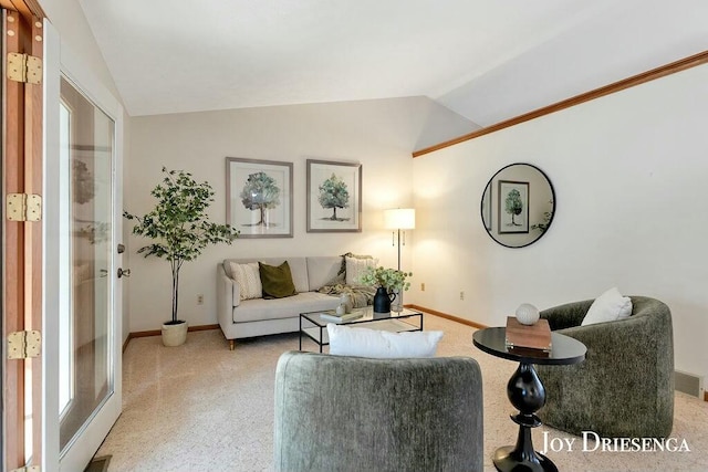 carpeted living room featuring lofted ceiling and baseboards