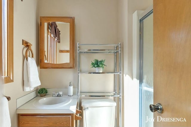 bathroom featuring toilet and vanity