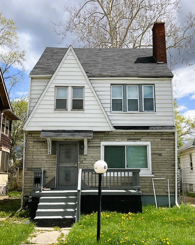 view of front of home featuring stone siding and a chimney