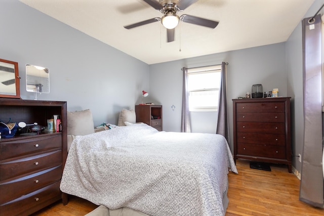 bedroom with light wood-type flooring and ceiling fan