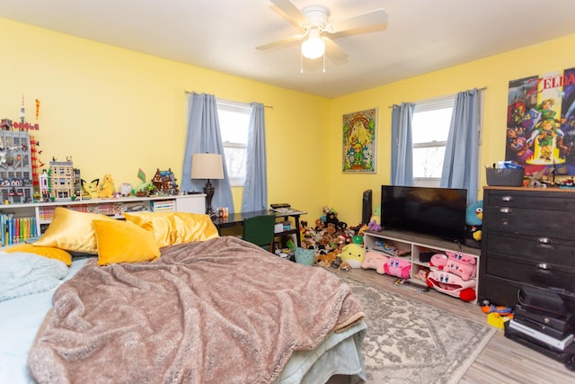 bedroom with wood finished floors and a ceiling fan