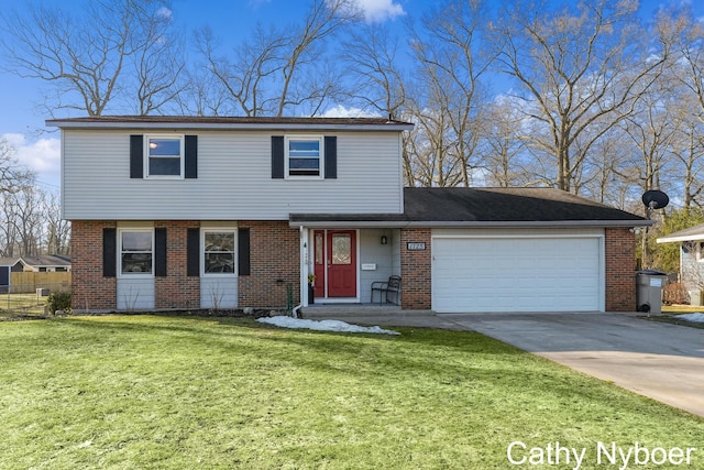 colonial inspired home featuring brick siding, driveway, an attached garage, and a front yard