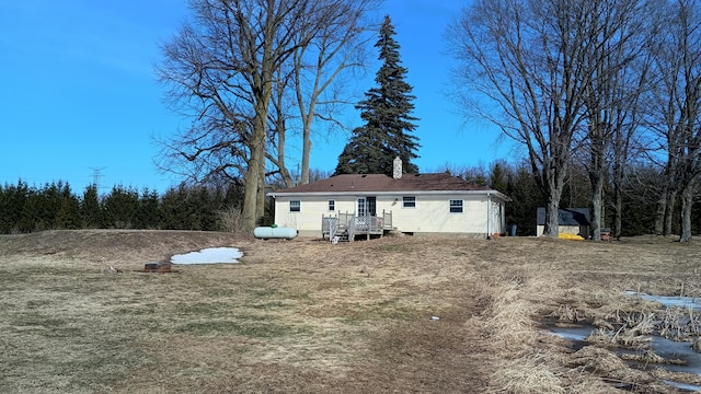 rear view of property featuring crawl space