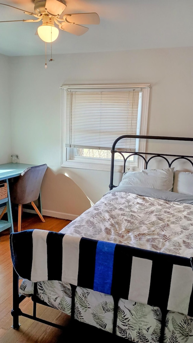 bedroom with ceiling fan and wood finished floors