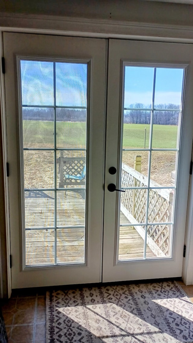 entryway with tile patterned floors and french doors