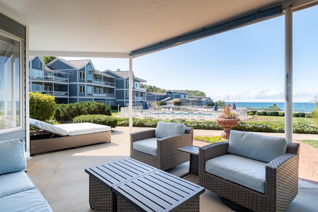 view of patio / terrace with an outdoor hangout area, a community pool, and a water view