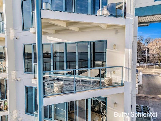 exterior space with a balcony and stucco siding