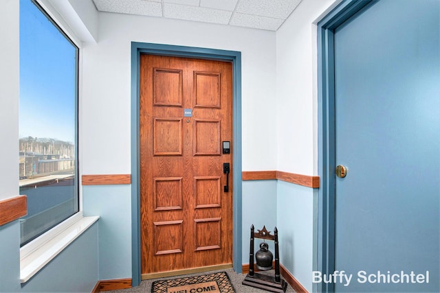 entrance foyer featuring a drop ceiling and baseboards