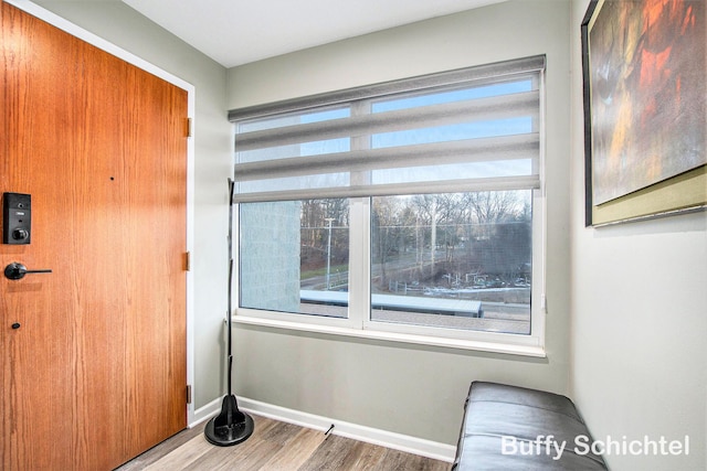 interior space featuring baseboards and wood finished floors