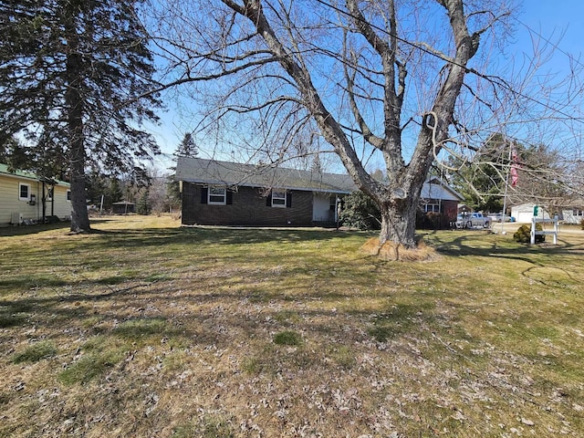 view of front of house with brick siding and a front yard