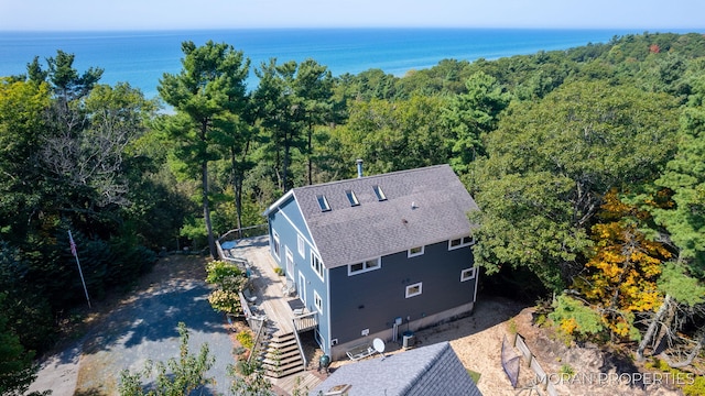 aerial view featuring a water view and a view of trees