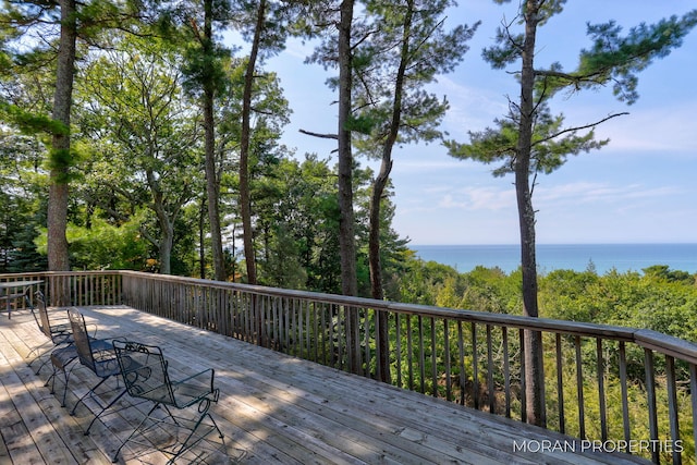 wooden terrace featuring a water view