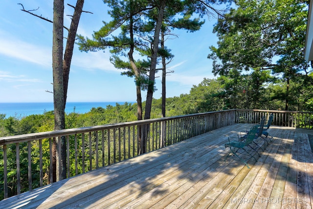 wooden terrace featuring a water view