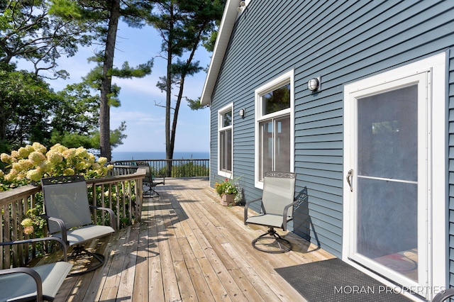 wooden deck featuring a water view