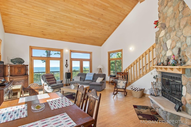 dining space featuring plenty of natural light, a fireplace, wood ceiling, and wood finished floors