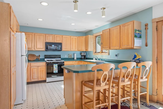 kitchen featuring freestanding refrigerator, gas stove, light brown cabinets, and black microwave