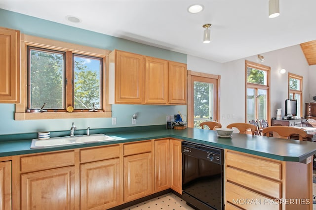 kitchen featuring light brown cabinets, a peninsula, a sink, dishwasher, and dark countertops