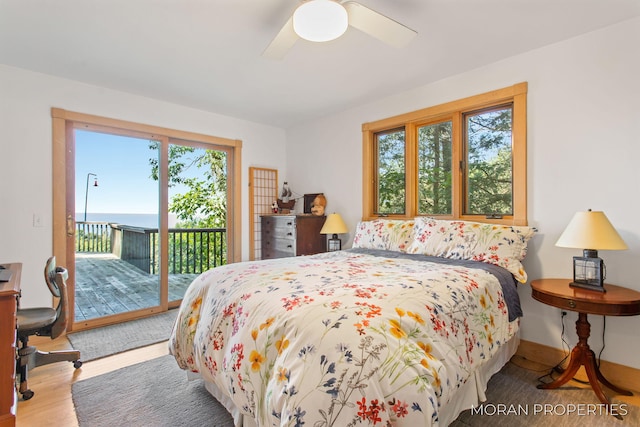 bedroom featuring baseboards, wood finished floors, a ceiling fan, and access to outside