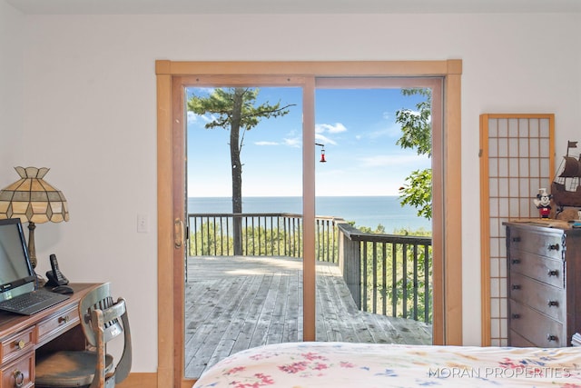 bedroom featuring a water view and access to outside