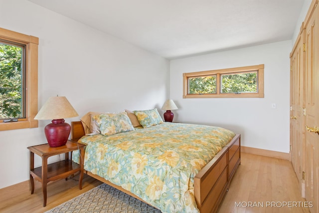 bedroom featuring light wood-style flooring and baseboards