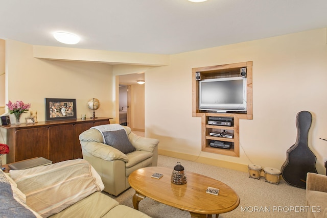 living area with baseboards and carpet floors