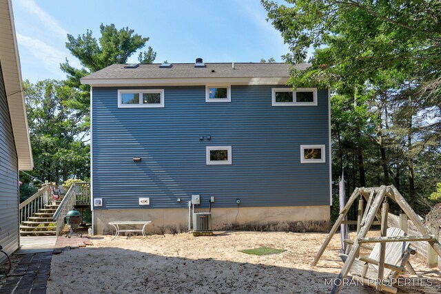 rear view of property with stairway and central AC unit