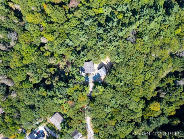 birds eye view of property with a wooded view